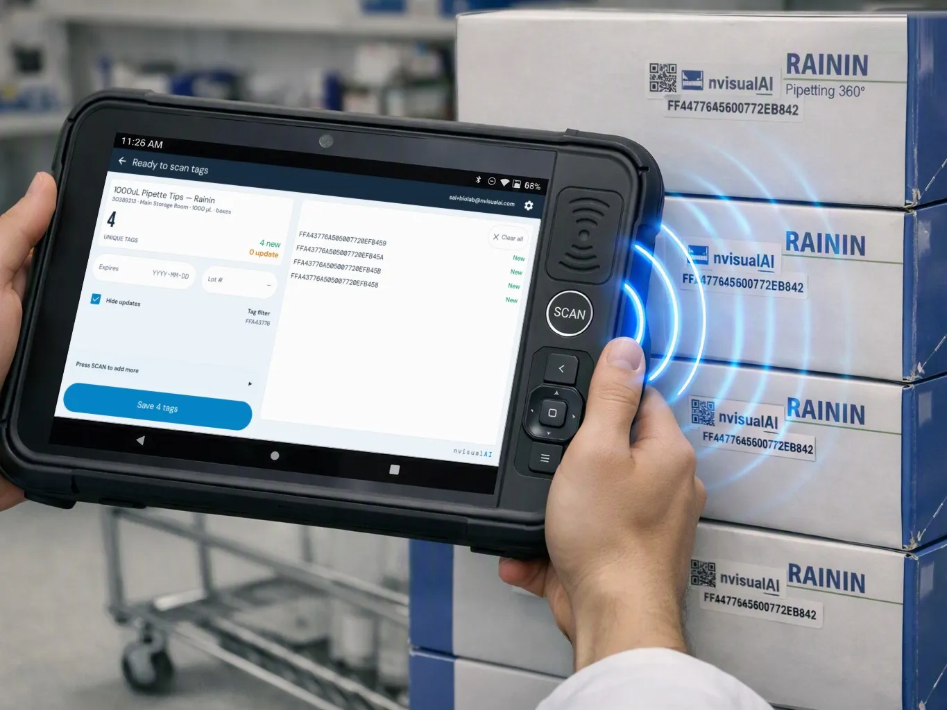 Hands holding a rugged RFID tablet next to a stack of tagged pipette tip boxes, with the nvisualAI registration screen showing four new tags for 1000 µL pipette tips and a Save 4 tags button